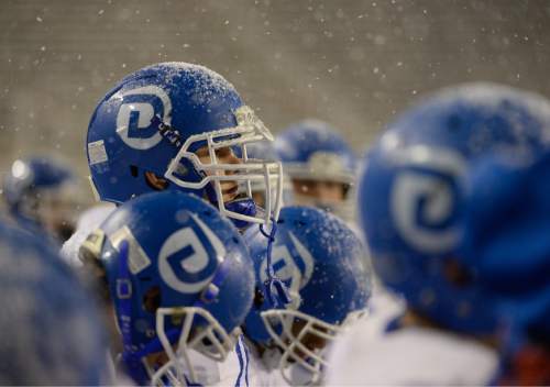 Francisco Kjolseth  |  The Salt Lake Tribune
Dixie players watch from the sidelines as the snow begins to fall during play against Pine View in the class 3AA state football semifinal game at Rice Eccles Stadium on Thursday, Nov. 13, 2014.