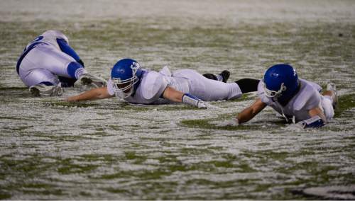 Francisco Kjolseth  |  The Salt Lake Tribune
Dixie players celebrate their win over Pine View by playing in the snow following the class 3AA state football semifinal game at Rice Eccles Stadium on Thursday, Nov. 13, 2014.