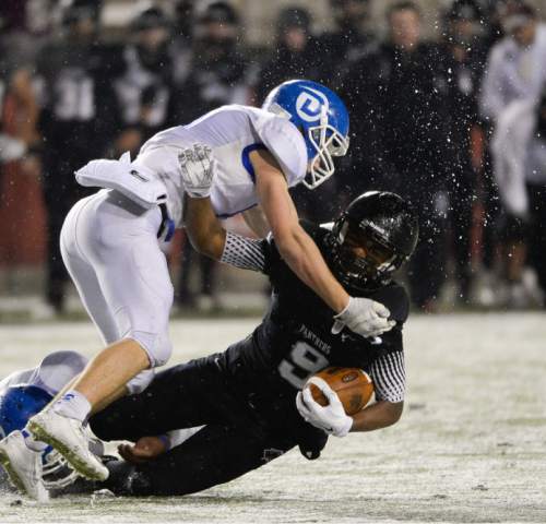 Francisco Kjolseth  |  The Salt Lake Tribune
Ice and snow go flying as Dixie's Jaden Harrison (6) hits Preston Allen (9) of Pine View in the class 3AA state football semifinal game at Rice Eccles Stadium on Thursday, Nov. 13, 2014.