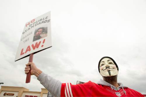 Rick Egan  |  The Salt Lake Tribune

Keven Irons chants behind a mask, during a rally in Saratoga Springs, for Darrien Hunt, who was fatally shot by two Saratoga Springs police officers on Sept. 10, 2014, after allegedly swinging a samurai-type sword at the officers.Friday, November 14, 2014