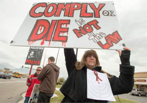 Rick Egan  |  The Salt Lake Tribune

Linda Spencer holds a sign, during a rally in Saratoga Springs, for Darrien Hunt, who was fatally shot by two Saratoga Springs, Friday, November 14, 2014