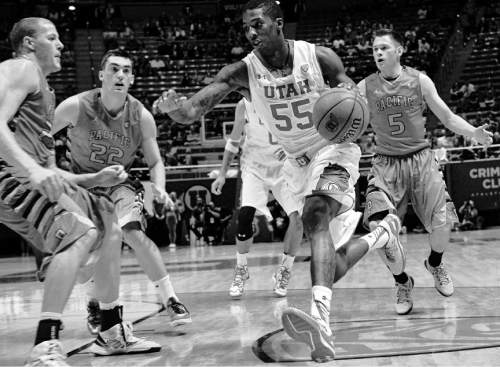 Chris Detrick  |  The Salt Lake Tribune
Utah Utes guard Delon Wright (55) runs past Pacific Boxers Skyler Burgess (23) Pacific Boxers Mitch Wettig (22) and Pacific Boxers Riley Grandinetti (5) during the game at the Huntsman Center Thursday November 6, 2014.