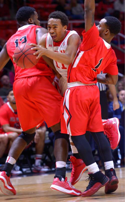 Leah Hogsten  |  The Salt Lake Tribune
Utah Utes guard Brandon Taylor (11) draws the foul on Ball State Cardinals guard Zavier Turner (1) while squeezing through Turner and Ball State Cardinals forward Bo Calhoun (12). The University of Utah leads Ball State University at the half during their home opener at the Jon M. Huntsman Center in Salt Lake City, November 14, 2014.