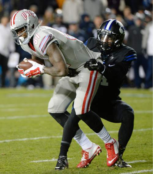 Steve Griffin  |  The Salt Lake Tribune

Brigham Young Cougars defensive back Robertson Daniel (4) wraps up UNLV Rebels wide receiver Devante Davis (81) during first half action in the BYU versus UNLV football game at LaVell Edwards Stadium in Provo, Saturday, November 15, 2014.