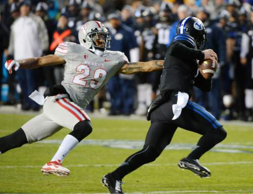 Steve Griffin  |  The Salt Lake Tribune

Brigham Young Cougars quarterback Christian Stewart (7) escapes the grasp of UNLV Rebels defensive back Tajh Hasson (29) as he runs the ball during first half action in the BYU versus UNLV football game at LaVell Edwards Stadium in Provo, Saturday, November 15, 2014.