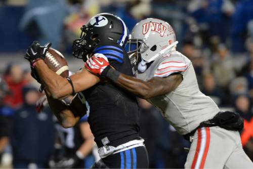 Steve Griffin  |  The Salt Lake Tribune

Brigham Young Cougars wide receiver Jordan Leslie (9) hauls in a pass in front of UNLV Rebels defensive back Sidney Hodge (4) during second half action in the BYU versus UNLV football game at LaVell Edwards Stadium in Provo, Saturday, November 15, 2014.