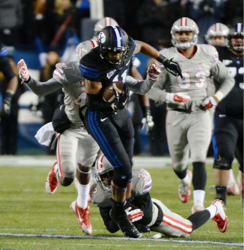 Steve Griffin  |  The Salt Lake Tribune

Brigham Young Cougars wide receiver Terenn Houk tries to escape the UNLV defense during first half action in the BYU versus UNLV football game at LaVell Edwards Stadium in Provo, Saturday, November 15, 2014.