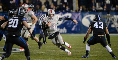 Steve Griffin  |  The Salt Lake Tribune

UNLV Rebels quarterback Jared Lebowitz (14) looks for running room during second haff action in the BYU versus UNLV football game at LaVell Edwards Stadium in Provo, Saturday, November 15, 2014.