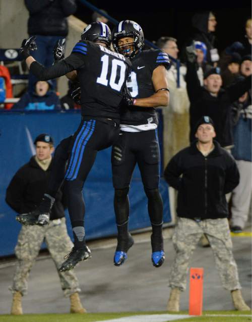 Steve Griffin  |  The Salt Lake Tribune

Brigham Young Cougars wide receiver Mitch Mathews (10) and Brigham Young Cougars wide receiver Jordan Leslie (9) leap onto the air as they celebrate Mathews' touchdown in second half action in the BYU versus UNLV football game at LaVell Edwards Stadium in Provo, Saturday, November 15, 2014.