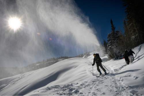 Scott Sommerdorf  |  The Salt Lake Tribune
Skiers above the Milly Express lift at Brighton Ski Resort pass by a snow-making machine, Sunday, November 16, 2014. Utah ski resorts are looking to open this next week, before the Thanksgiving holiday, but most of the base will be machine-made snow.