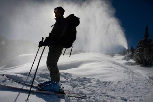 Scott Sommerdorf  |  The Salt Lake Tribune
A skier pauses before heading down the last hill above the Milly Express lift at Brighton Ski Resort, Sunday, November 16, 2014. One of the resort's snow-making machines is at work behind him. Utah ski resorts are looking to open this next week, before the Thanksgiving holiday, but most of the base will be machine-made snow., Sunday, November 16, 2014.