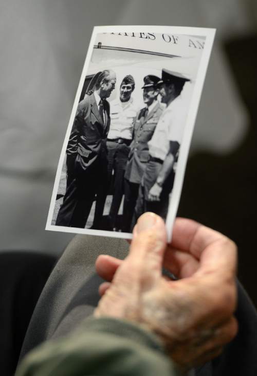 Francisco Kjolseth  |  The Salt Lake Tribune
The Utah Air National Guard Base east of SLC International is renamed for retired Brig. Gen. Roland Wright, who flew the "Mormon Mustang" during World War II, seen holding a historical photograph of himself with president Gerald Ford.