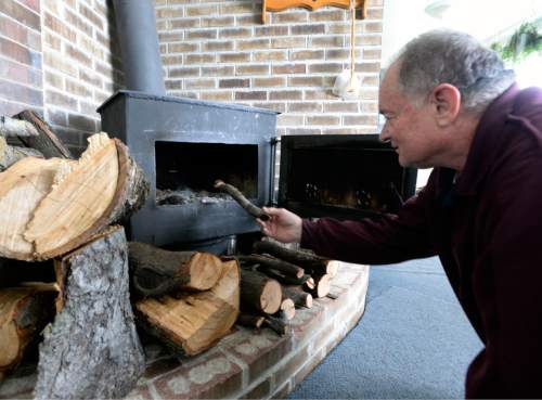 Al Hartmann  |  The Salt Lake Tribune
Doug Fay of Kearns stokes his homemade steel plate wood stove a friend built in 1977.  He has used it as his only heat source, but this year Breathe Utah covered the cost of replacing his broken gas furnace. Wood smoke plays a surprisingly large impact on the Wasatch Front's wintertime air quality so the state is encouraging residents to convert wood-burning devices to natural gas.