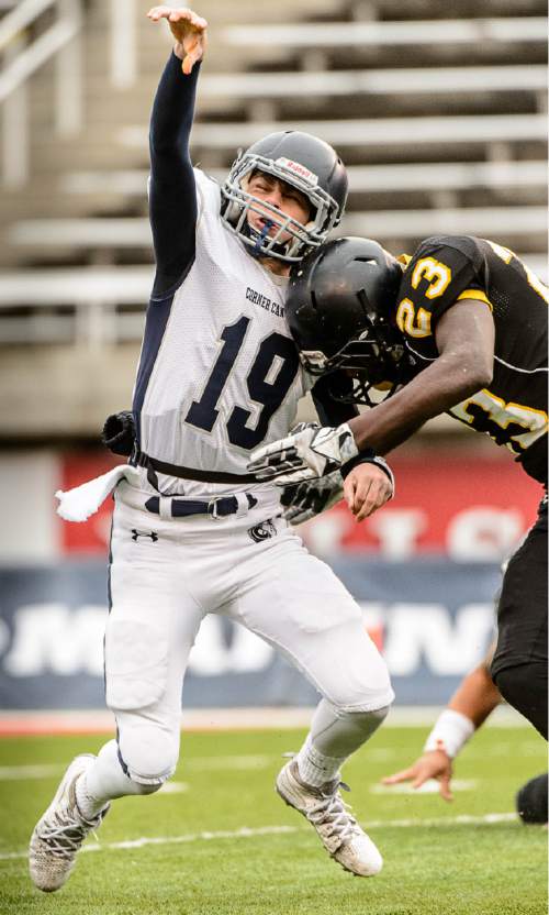 Trent Nelson  |  The Salt Lake Tribune
Corner Canyon's Kyle Reaveley is hit by Roy's Nate Jones after releasing a pass as Corner Canyon faces Roy High School in a  4A state football semifinal game at Rice-Eccles Stadium in Salt Lake City, Friday November 14, 2014.