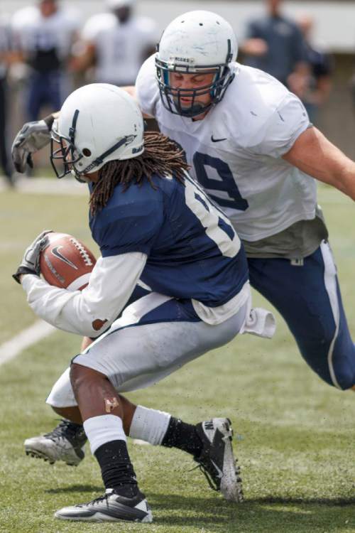 Trent Nelson  |  The Salt Lake Tribune
Defensive lineman B.J. Larsen moves in to tackle Chuck Jacobs at Utah State's annual Blue and White football game Saturday, April 28, 2012 in Logan, Utah.