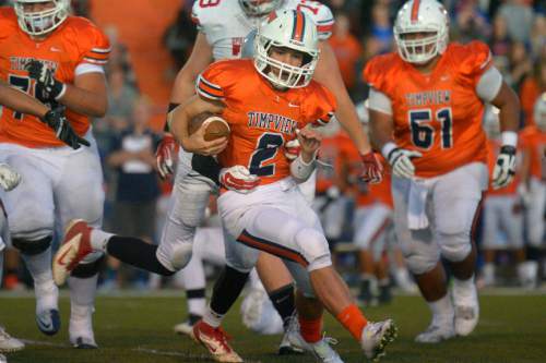 Chris Detrick  |  The Salt Lake Tribune
Timpview's Britain Covey (2) runs for a touchdown during the game at Timpview High School Thursday October 2, 2014. Timpview is winning the game 41-0 at halftime.