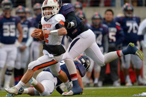 Chris Detrick  |  The Salt Lake Tribune
Timpview's Britain Covey (2) evades a tackle from Woods Cross's Jared Clark (9) during the 4A state football semifinal game at Rice-Eccles Stadium Friday November 14, 2014.