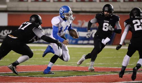 Francisco Kjolseth  |  The Salt Lake Tribune
Ammon Takau (14) of Dixie finds a small line against Pine View in the class 3AA state football semifinal game at Rice Eccles Stadium on Thursday, Nov. 13, 2014.