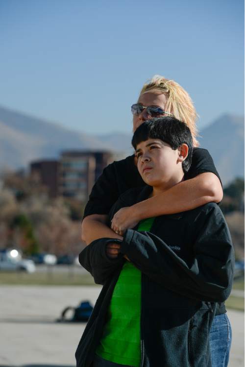 Francisco Kjolseth  |  The Salt Lake Tribune
Melanie Torres of Salt Lake embraces her son Diego, 13, as she attends a press event held by Latino activists and families on the South steps of the Utah Capitol on Friday, Nov. 21, 2014, to talk about President Obama's immigration executive order. Melanie, who's husband is from Mexico and has been in the states for 18 years has experienced first hand discrimination and is hopeful that the latest news from the White House will ease some of the fear her family has lived with.
