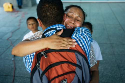 Tribune file photo
 Ana Canenguez (rear) hugs (front) Israel Valerdi (front) following a prayer vigil at the Wallace Bennett Federal Building in Salt Lake City last year. Canenguez, who has been fighting deportation to El Salvador, remains in the state.