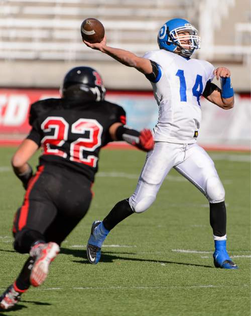 Trent Nelson  |  The Salt Lake Tribune
Dixie's Ammon Takau throws the ball as Hurricane faces Dixie High School in the 3AA state championship game at Rice-Eccles Stadium in Salt Lake City Friday November 21, 2014.