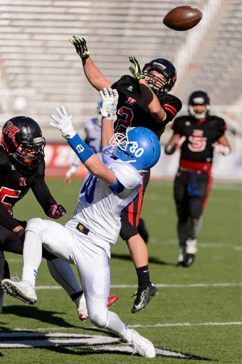 Trent Nelson  |  The Salt Lake Tribune
Hurricane's Jason Stanworth (2) knocks the ball away from Dixie's Logan Schweitzer (80) and into the hands of Nicholas McDaniel for a turnover as Hurricane faces Dixie High School in the 3AA state championship game at Rice-Eccles Stadium in Salt Lake City Friday November 21, 2014.