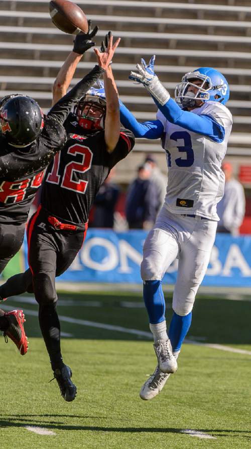 Trent Nelson  |  The Salt Lake Tribune
Hurricane's Noah Elison (12) knocks the ball away from Dixie's Traton Miller (3) as Hurricane faces Dixie High School in the 3AA state championship game at Rice-Eccles Stadium in Salt Lake City Friday November 21, 2014.