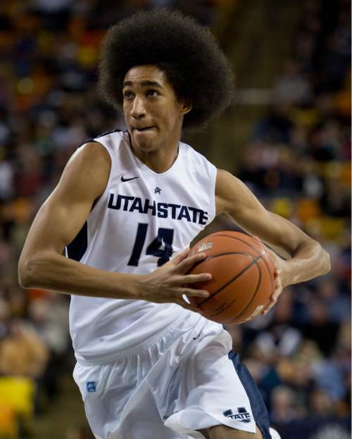 Trent Nelson  |  The Salt Lake Tribune
Utah State Aggies guard/forward Jalen Moore (14) with the ball, as Utah State University hosts Colorado State, NCAA basketball, Wednesday January 15, 2014 in Logan.