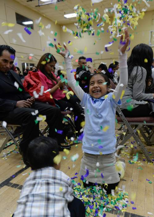 Francisco Kjolseth  |  The Salt Lake Tribune
Leslie Soledad, 7, is joined by her brother Brian, 4, as they throw confetti into the air following the news the family was following at Centro Civico Mexicano from the White House during the historic announcement by President Barack Obama to transform immigration policy and spare 5 million from deportation.