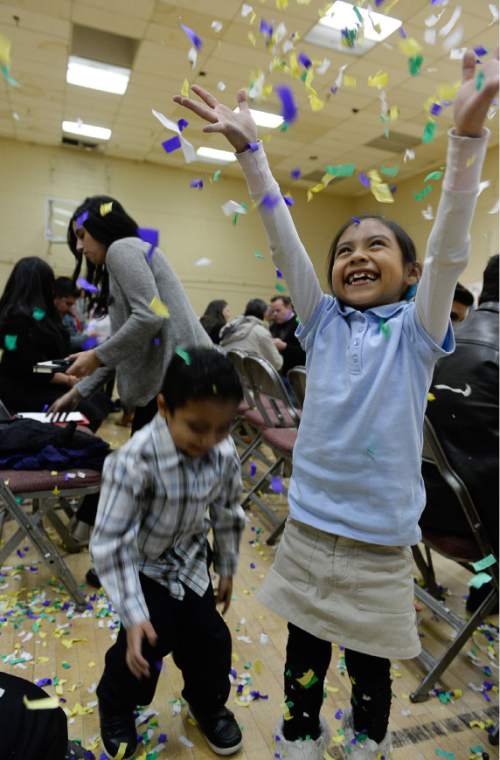 Francisco Kjolseth  |  The Salt Lake Tribune
Leslie Soledad, 7, is joined by her brother Brian, 4, as they throw confetti into the air following the news the family was following at Centro Civico Mexicano from the White House during the historic announcement by President Barack Obama to transform immigration policy and spare 5 million from deportation.