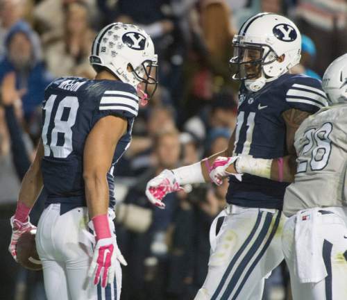 Rick Egan  |  The Salt Lake Tribune

Brigham Young Cougars wide receiver Terenn Houk (11) congratulates Brigham Young Cougars wide receiver Keanu Nelson (18) after Nelson's  fourth quarter touchdown, in football action, BYU vs The Nevada Wolf Pack at Lavell Edwards Stadium, Saturday, October18, 2014