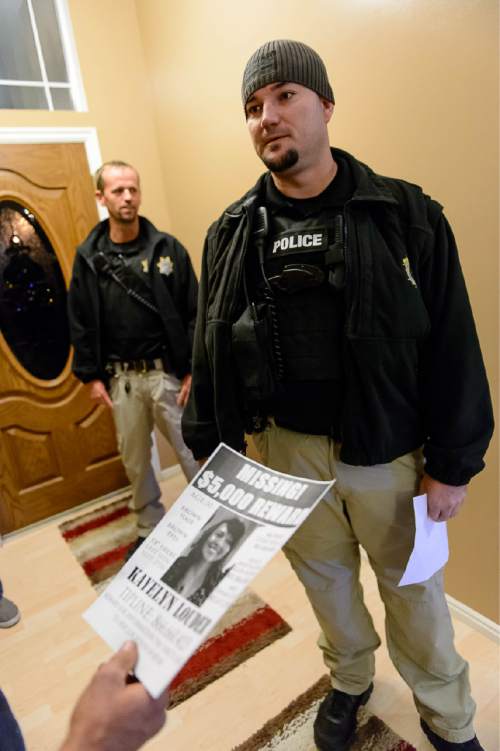 Trent Nelson  |  The Salt Lake Tribune
During a visit to the home of a probationer in West Jordan Wednesday November 19, 2014, agents Jason Fairbanks, left, and Brian Peterson hand out a flier with information on Kayelyn Louder, who disappeared from her home in Murray on Sept. 27. Adult Probation and Parole agents handed out fliers throughout the Salt Lake valley to raise awareness of the case.
