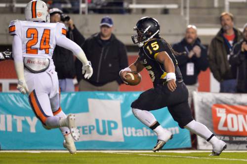 Chris Detrick  |  The Salt Lake Tribune
Roy's Baby Eteuati (15) runs for a touchdown past a Timpview defender (who's name is not listed in the roster) during the 4A state championship game at Rice-Eccles Stadium Friday November 21, 2014.