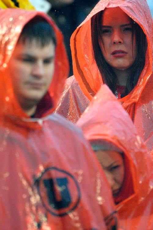 Chris Detrick  |  The Salt Lake Tribune
Utah fans attempt to keep dry during the game at Rice-Eccles Stadium Saturday November 22, 2014. Arizona Wildcats defeated Utah Utes 42-10.