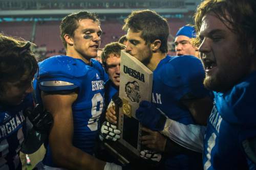 Chris Detrick  |  The Salt Lake Tribune
Bingham's Chayden Johnston (12) kisses the trophy after winning the 5A state championship game at Rice-Eccles Stadium Friday November 21, 2014. Bingham defeated American Fork 20-3.