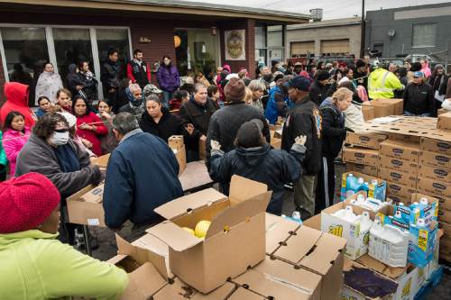 Trent Nelson  |  The Salt Lake Tribune
Volunteers hand out frozen turkeys, food and other necessities to needy families at Lutheran Social Service of Utah in Salt Lake City Tuesday November 25, 2014.