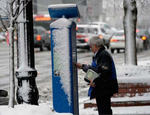 Al Hartmann  |  The Salt Lake Tribune
Man pays for parking at a snow-plastered kiosk in Salt Lake City during the first major winter snow storm of the season along the Wasatch front Tuesday December 3.