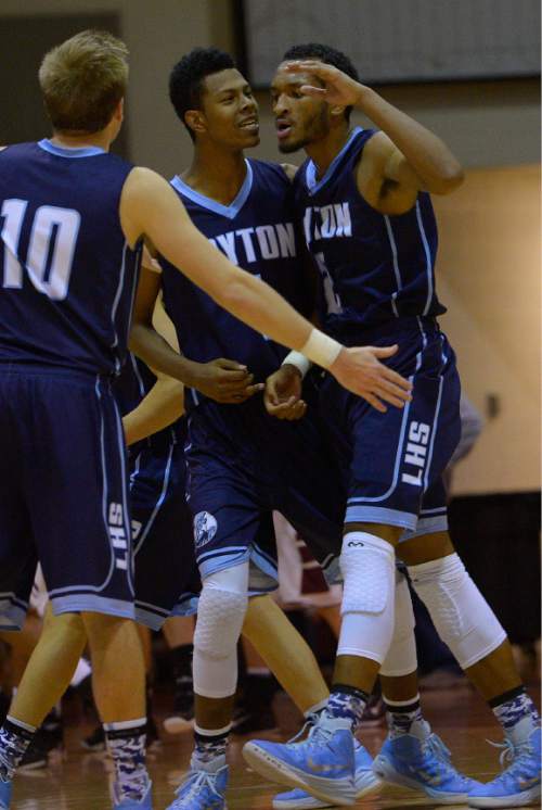 Leah Hogsten  |  The Salt Lake Tribune
Jakoby Kemp and Jarriesse Blackmon celebrate a play with Matt Cragun. Lone Peak High School defeated Layton High School 73-70, Tuesday, November 25, 2014 in Highland.