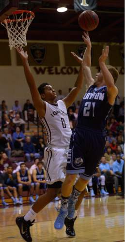 Leah Hogsten  |  The Salt Lake Tribune
Layton's Boston Armitstead shoots around Lone Peak's Chantry Ross. Lone Peak High School defeated Layton High School 73-70, Tuesday, November 25, 2014 in Highland.