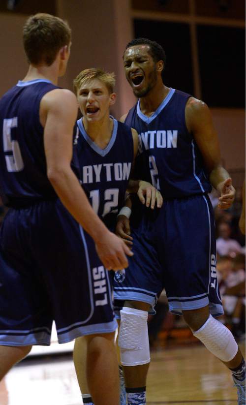 Leah Hogsten  |  The Salt Lake Tribune
l-r Steel Roberts, Dallin Watts and Jarriesse Blackmon celebrate a play. Lone Peak High School defeated Layton High School 73-70, Tuesday, November 25, 2014 in Highland.