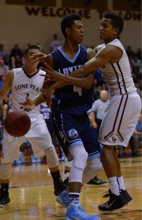 Leah Hogsten  |  The Salt Lake Tribune
Lone Peak's Chantry Ross knocks the ball from the hand of Layton's Jakoby Kemp.  Lone Peak High School defeated Layton High School 73-70, Tuesday, November 25, 2014 in Highland.