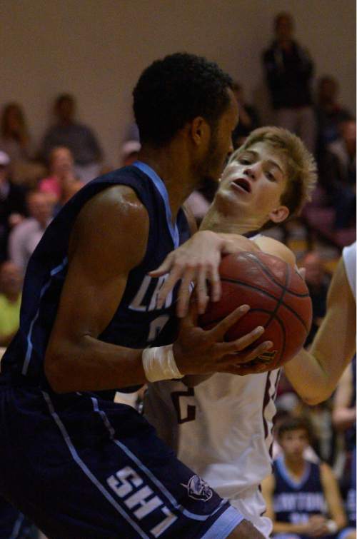 Leah Hogsten  |  The Salt Lake Tribune
Lone Peak's Garrett Frampton fouls Layton's Jarriesse Blackmon. Lone Peak High School defeated Layton High School 73-70, Tuesday, November 25, 2014 in Highland.