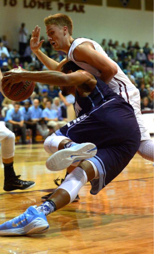 Leah Hogsten  |  The Salt Lake Tribune
Layton's Jarriesse Blackmon falls on Lone Peak's Nick Curtis.  Lone Peak High School defeated Layton High School 73-70, Tuesday, November 25, 2014 in Highland.