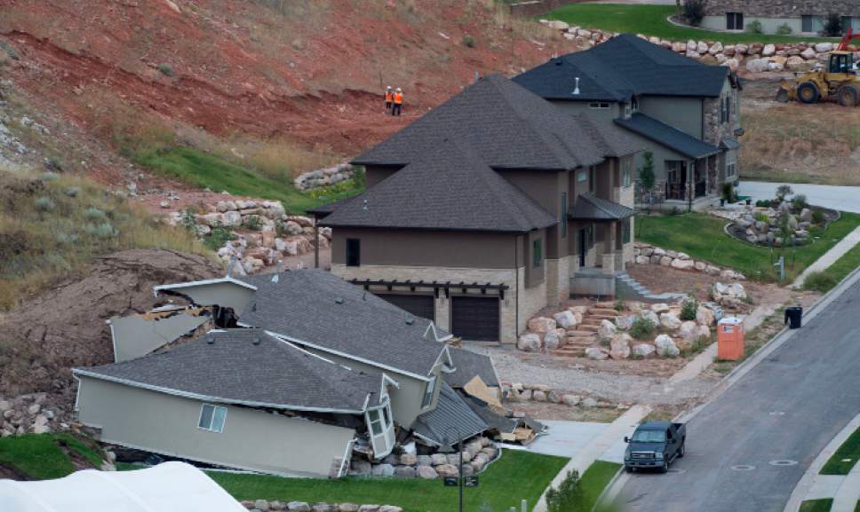 Steve Griffin  |  Tribune file photo
Heavy rains caused the mountain side to slide, destroying a home, bottom, Tuesday, August 5, 2014.