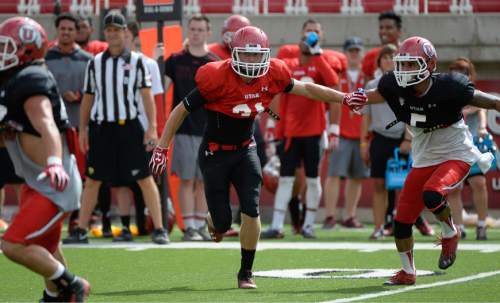 Francisco Kjolseth  |  The Salt Lake Tribune
Ryan Petersen works to stay in play as the University of Utah football team holds practice at Rice Eccles stadium on Tuesday morning, Aug. 12, 2014.