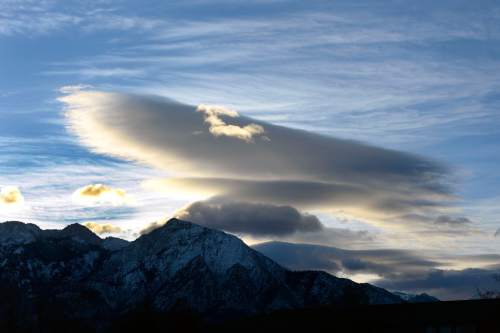 Al Hartmann  |  The Salt Lake Tribune
Lenticular cloud hovers over Mount Olympus like a flying saucer as the sun rises over the valley Wendesday November 26.