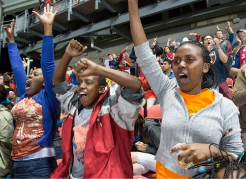 Rick Egan  |  The Salt Lake Tribune

(From left to right) Ines, Philip and Yvette Bugingo react to a Real Salt Lake goal as they attend their first Soccer match in the U.S. on Aug. 12, 2014.