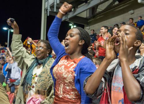Rick Egan  |  The Salt Lake Tribune

(From left to right) Godelive, Ines, and Philip Bugingo react to a Real Salt Lake goal as they attend their first Soccer match in the U.S. on Aug. 12, 2014.