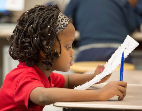 Rick Egan  |  The Salt Lake Tribune

Eight-year-old Alia Bugingo works on an assignment in her second grade class at North Star Elementary Nov. 19, 2014.