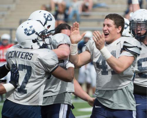 Rick Egan  |  The Salt Lake Tribune

Nick Vigil (41) celebrates with Devin Centers (37) as they celebrate a game winning blocked kick, in the Utah State Aggie's final spring scrimmage, Saturday, April 12, 2014. A flag was thrown for roughing the kicker on the play.
